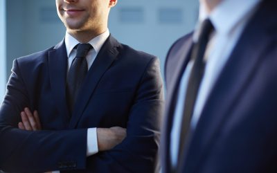 Cropped image of a confident businessman standing near his colleague on the foreground